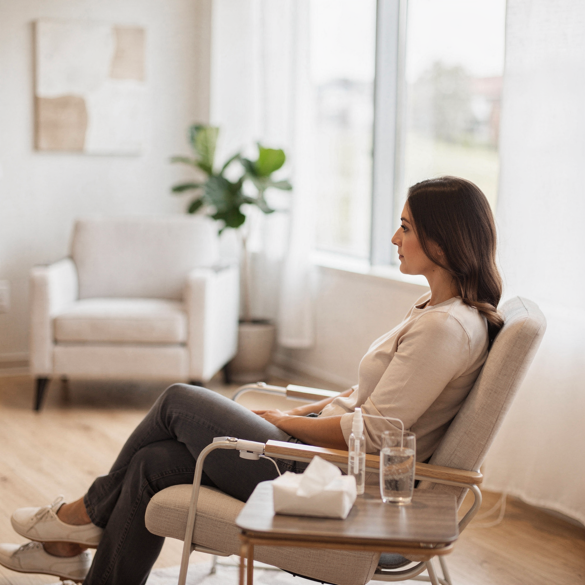 Patient sitting in a comfortable chair during Spravato treatment in a bright, modern clinic room